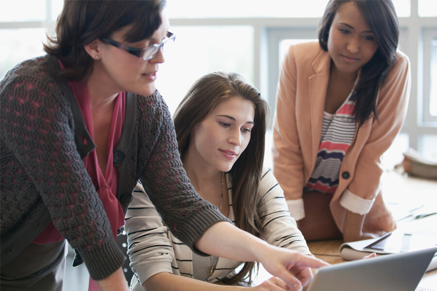 A female lecturer and two young women students